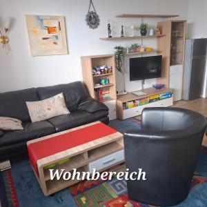 a living room with a couch and a tv at Wanderglück in Missen-Wilhams