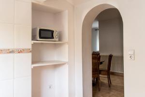 a kitchen with a microwave sitting on a shelf at Blanch 1 in Tremp