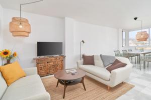 a living room with two couches and a tv at Casa Bellota in Torrox