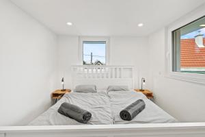 a white bedroom with a large bed with two windows at Villa Jäger mit Pool in Wien in Vienna +35 photos