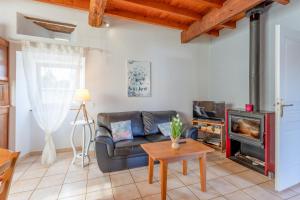 a living room with a couch and a fireplace at Gite La Bergerie près de Lourdes in Adé +14 photos