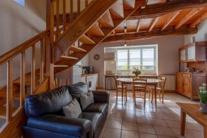 a living room with a couch and a table at Gite La Bergerie près de Lourdes in Adé