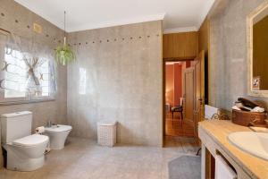 a bathroom with a toilet and a sink at Casa da Cidade de Loulé in Loulé +27 photos