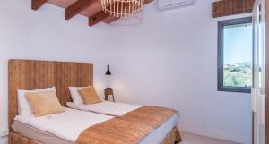 a bedroom with a bed with white walls and a window at Finca Sa Real in Cala Millor +9 photos