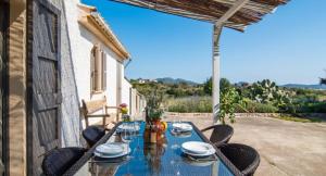 a table and chairs on a patio with a view at Finca Sa Real in Cala Millor