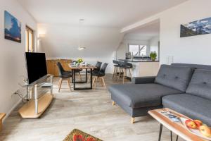 a living room with a couch and a table at Über der alten Gärtnerei in Allensbach
