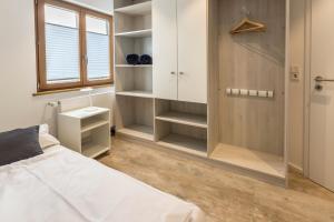 a bedroom with a bed and a closet with shelves at Über der alten Gärtnerei in Allensbach