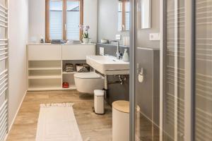 a bathroom with a sink and a toilet at Über der alten Gärtnerei in Allensbach +20 photos