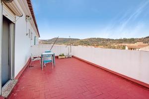 a patio with two chairs and a table on a balcony at Atico con doble terraza Jerica in Jérica
