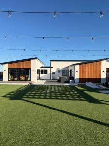 a rendering of a building with a grass field at Darfield Retreat in Darfield