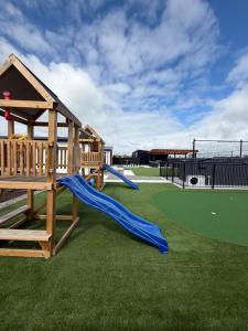 a playground with a slide and a slideintend at Darfield Retreat in Darfield