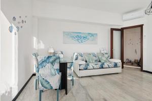 a living room with a couch and a table and chairs at Linda's Pet Friendly Beach House in Rapallo