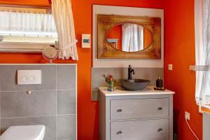 a bathroom with a sink and a mirror at Finnhütte Hohe Klinge Trusetal in Brotterode +23 photos