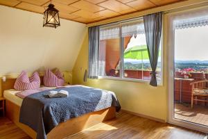 a bedroom with a bed and a large window at Finnhütte Hohe Klinge Trusetal in Brotterode