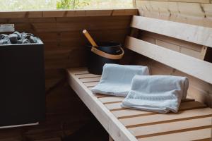 a sauna with two towels sitting on a wooden deck at Apartments Hofmann in Prateria +76 photos