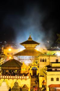 a view of a building with a tower at night at Hotel Thakali Inn in Kathmandu