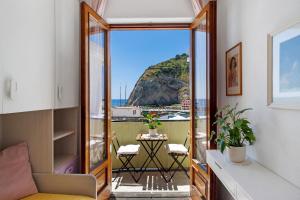 a room with a balcony with a view of the ocean at Casatullio - Sant'Angelo d'Ischia in Sant'Angelo D'Ischia