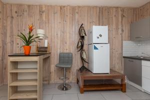 a kitchen with a refrigerator and a chair at Studio Cosy Climatisé, Cap Bretron in Capbreton +17 photos