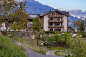 a house on a hill with a winding road at Oberfallerhof Apartment Inni in Barbiano