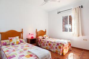 a bedroom with two beds and a window at Casa - 2 Mar y Sombra in Barbate +23 photos