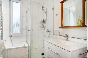 a bathroom with a shower and a sink at Siravit Am See in Friedrichshafen +16 photos