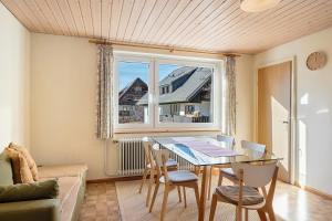 a dining room with a table and chairs and a window at Haus Doktor Saeltzer in Lenzkirch