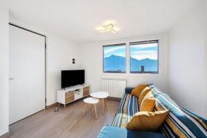 a living room with a couch and a tv at Cà De Qualì in Costa Volpino