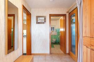a hallway leading to a bathroom with a toilet at Haus Doktor Saeltzer in Lenzkirch +80 photos