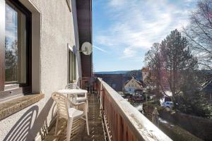 a balcony with two chairs and a table and a window at Haus Doktor Saeltzer in Lenzkirch