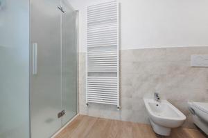 a bathroom with a shower and a sink and a toilet at Cà De Qualì in Costa Volpino +17 photos