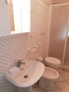 a bathroom with a white sink and a toilet at Il Mirto in Marciana
