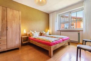 a bedroom with a large bed and a window at Kranichnest in Lüdershagen