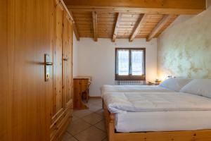 a bedroom with a bed and a window at Agriturismo Val d' Egoi 3 in Tremosine Sul Garda