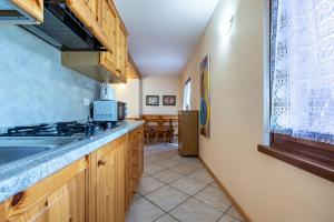a kitchen with a sink and a stove at Agriturismo Val d' Egoi 3 in Tremosine Sul Garda