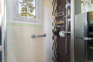 a bathroom with a shower with a window at Sun Canigou in Vernet-les-Bains +19 photos