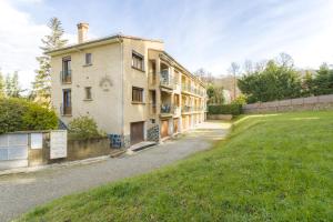 an old building with a grass field next to it at Sun Canigou in Vernet-les-Bains