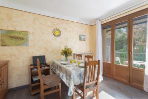 a dining room with a table and chairs and a window at Sun Canigou in Vernet-les-Bains