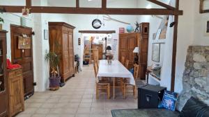 a dining room with a table and some chairs at Chambres D'hôtes Le Bellevue - in Montbrun-les-Bains +29 photos