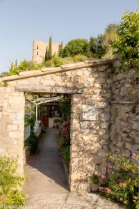an entrance to a garden with a stone wall at Chambres D'hôtes Le Bellevue - in Montbrun-les-Bains