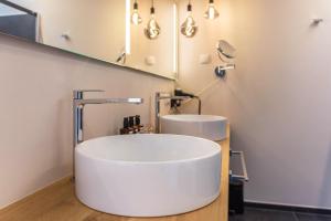 a bathroom with a white tub and a sink at Aura Chalets - Nr 3 in Castelrotto +24 photos