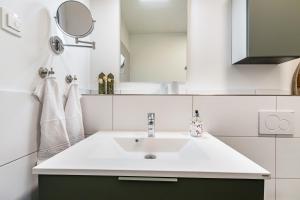 a bathroom with a sink and a mirror at Snorrum Wohnung 7 in Husby