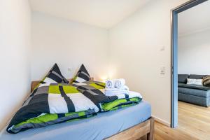 a bedroom with a bed with a mirror at Snorrum Wohnung 7 in Husby