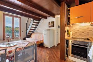 a kitchen with a refrigerator and a living room at Lerici – Foyer Verde Mare in Pugliola