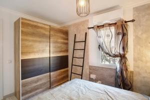 a bedroom with a bed and a ladder and a window at Vista Roja in San Agustin +34 photos