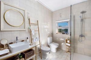 a bathroom with a toilet and a sink and a shower at Sobreiro22 in Lourosa