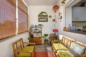 a living room with two chairs and a table at Sobreiro22 in Lourosa +25 photos