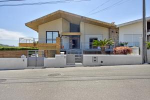 a house with a white fence in front of it at Sobreiro22 in Lourosa