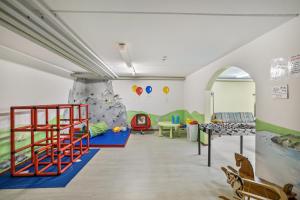 a childrens play room with a rock wall at Fewo mit Bergblick, Pool, Sauna in Oberaudorf