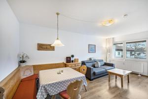 a living room with a table and a couch at Fewo mit Bergblick, Pool, Sauna in Oberaudorf