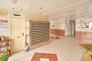 a large room with a brick wall and a door at Torresol 208 in Nerja +22 photos
